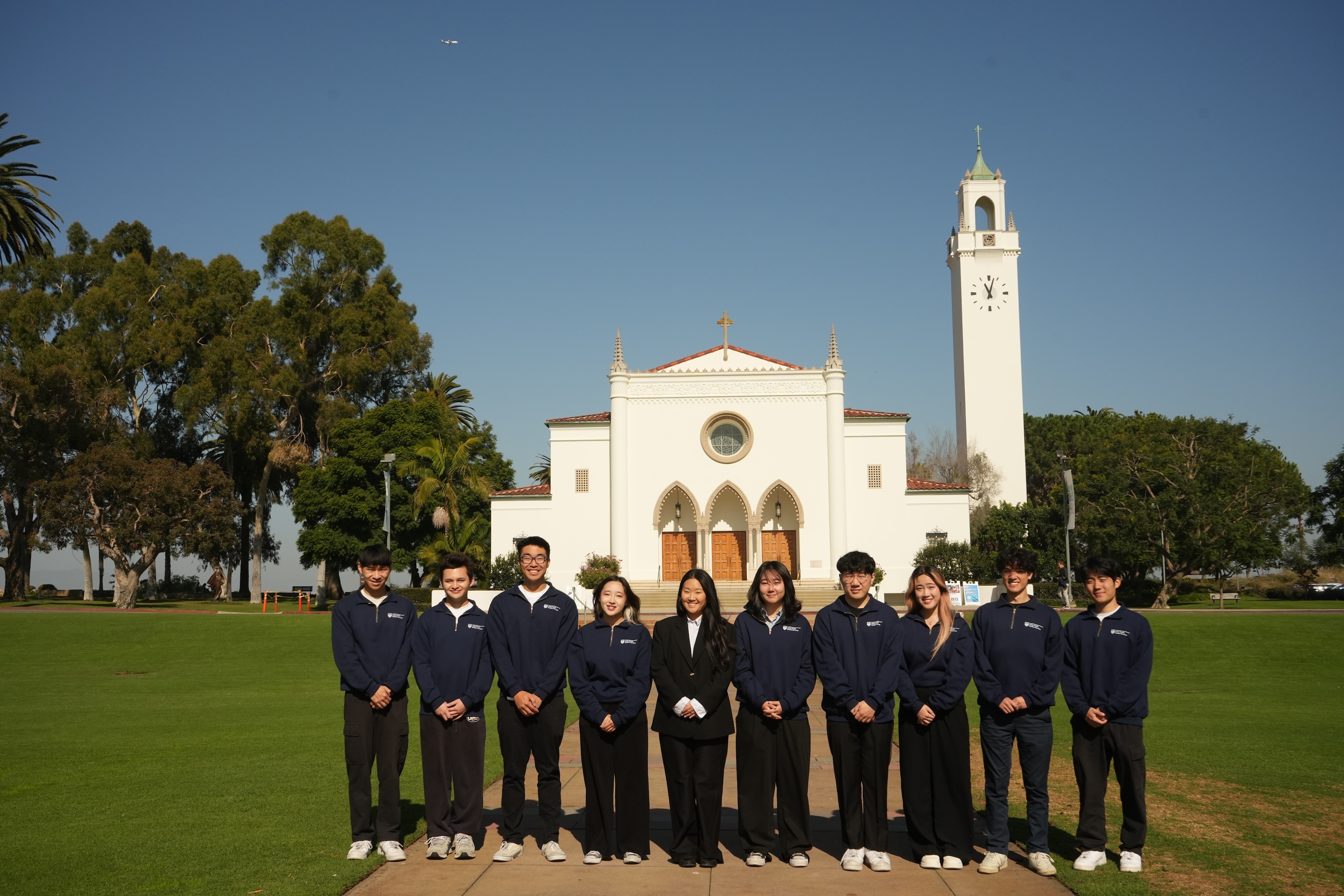 2025-2026 APSS team in front of the Sacred Heart Chapel